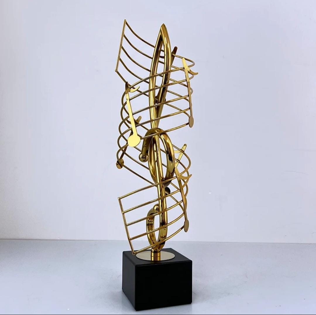 Golden metal statue shaped like a musical note