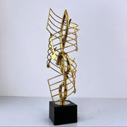Golden metal statue shaped like a musical note