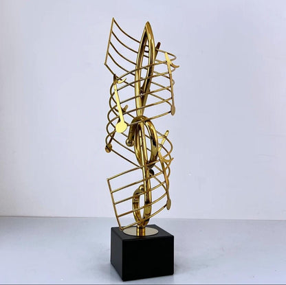 Golden metal statue shaped like a musical note