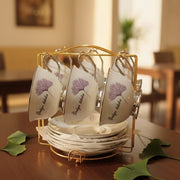 Bone china cup and saucer set with 6 white and silver cups, 6 saucers, and gold display stand.