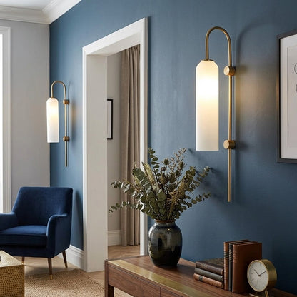 Minimalist brass wall mounted light fixture with frosted glass diffuser and modern gooseneck design.