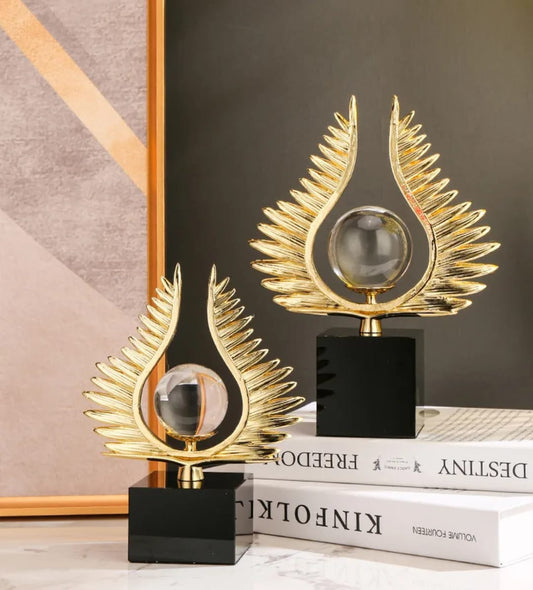 Decorative wing statue holding a crystal ball, designed for desktop or console table décor with a modern artistic style. ✨