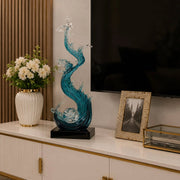 Dawood Lifestyle & Gadgets kes 75cm ocean wave resin sculpture featuring flowing blue and clear translucent waves spiralling around a crystal ball on a black display base.