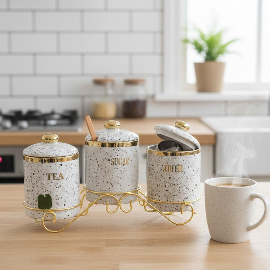 4-piece Marble canister set with three sugar containers and gold stand for kitchen organization.