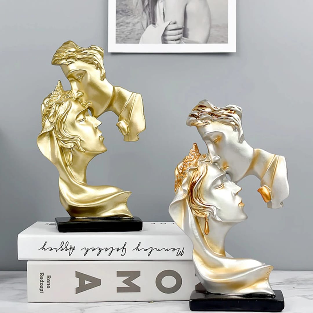 Dawood Lifestyle & Gadgets kes romantic couple statue featuring a forehead kiss design on a black base, available in classic gold and silver with gold accents.