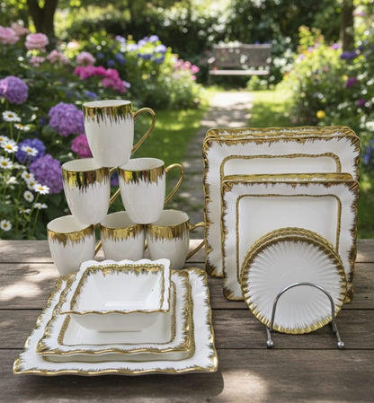 30 piece white ceramic dinner set with gold detailing, including plates, bowls, mugs, and saucers