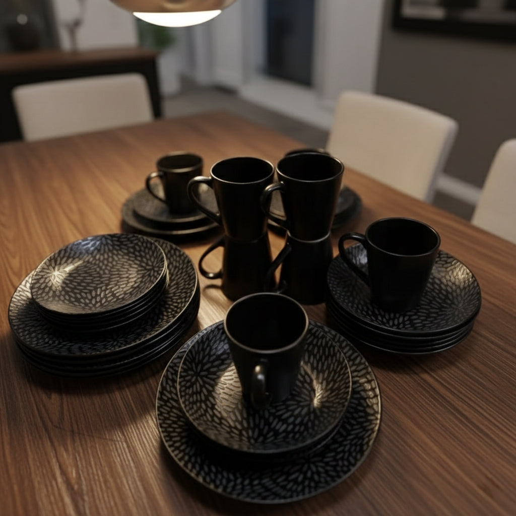 Black twenty four piece dinner set with cups, bowls, side plates, and dinner plates.