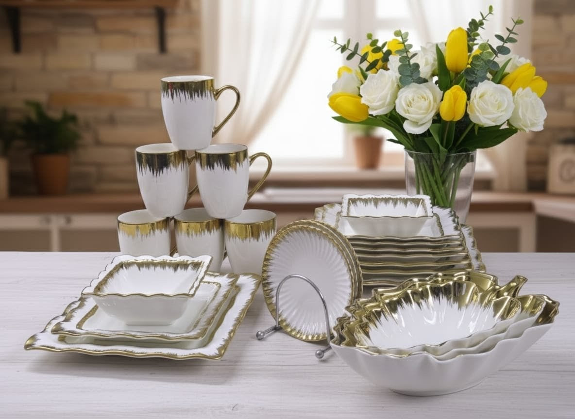 33-piece white ceramic dinner set with gold detailing, including plates, bowls, mugs, saucers, and serving bowls.