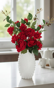 Artificial rose arrangement in plastic vase for home décor.
