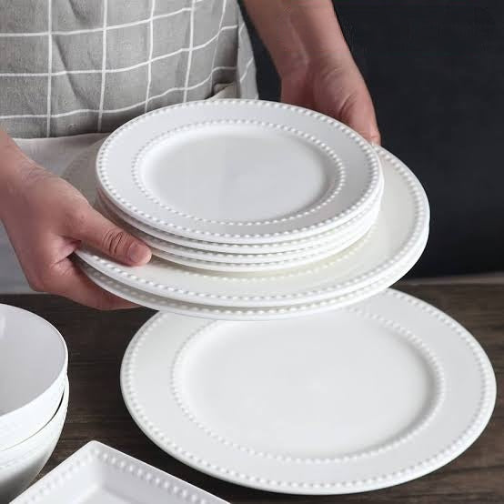 24 piece ceramic dotted dinner set including 11 inch dinner plates 8 inch side plates 6 inch bowls and 300ml cups for family dining and entertaining.