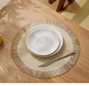 Set of six 38 cm round braided heat-resistant table mats.