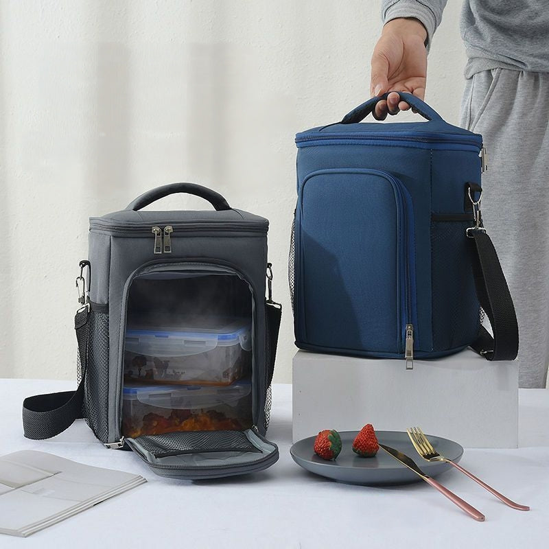 Two-compartment insulated lunch bag with crossbody strap in black, grey, and blue.