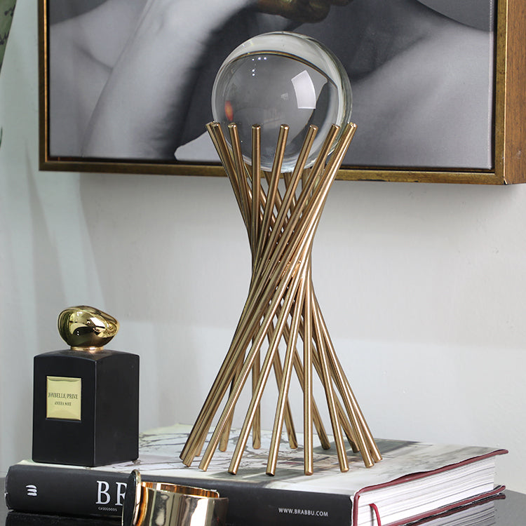 Decorative metal stand holding a crystal ball, designed as an elegant tabletop ornament for home or office décor. ✨