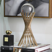 Decorative metal stand holding a crystal ball, designed as an elegant tabletop ornament for home or office décor. ✨