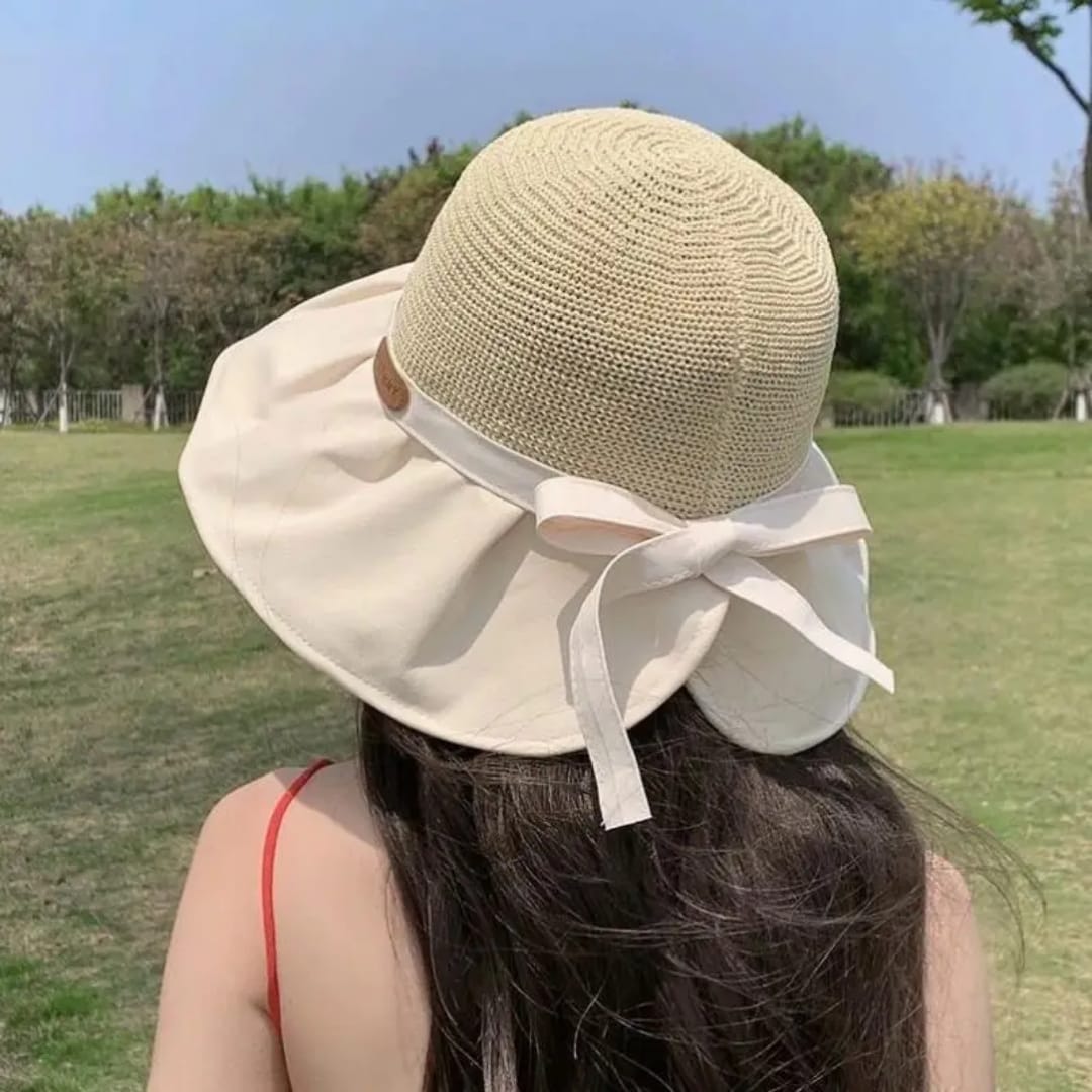 Women’s summer sun protection hat with large brim and butterfly knot design for UV protection and outdoor wear. 