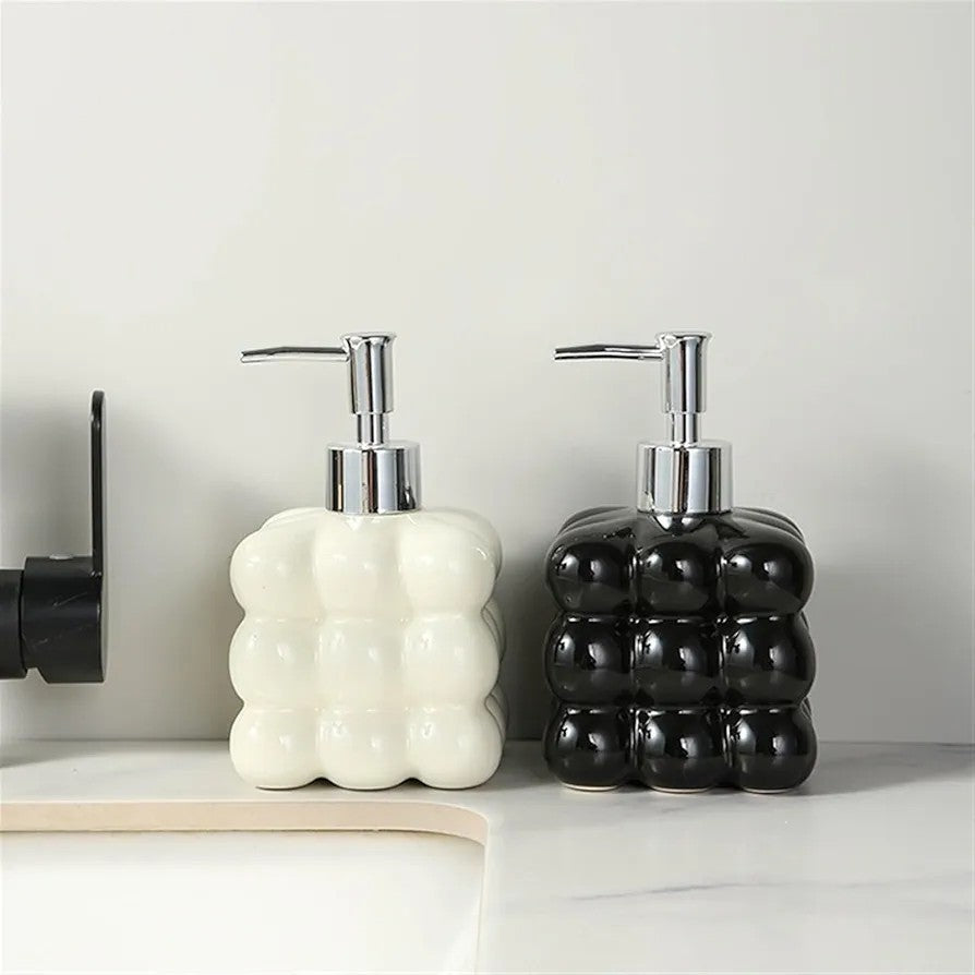 Bubble glass soap dispenser refillable pump bottle in black and white for bathroom and kitchen use.