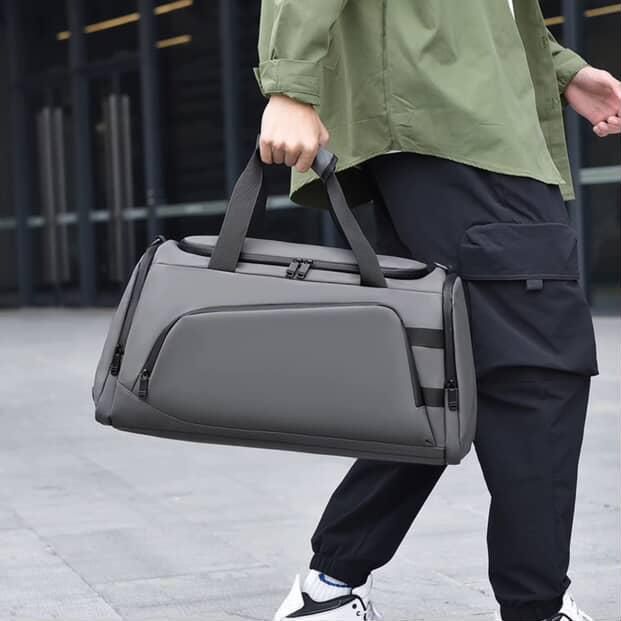 Waterproof duffel bag with shoe compartment and backpack straps in black and grey