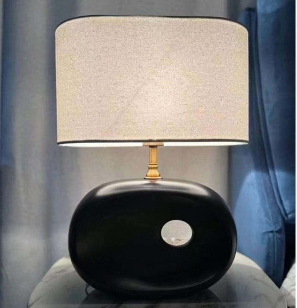 Black pebble table lamp with sculpted base for bedroom or living room lighting