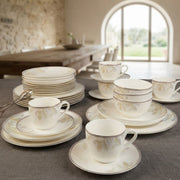 36 piece white floral ceramic dinner set with dinner plates, side plates, bowls, cups, saucers, and plate bowls.