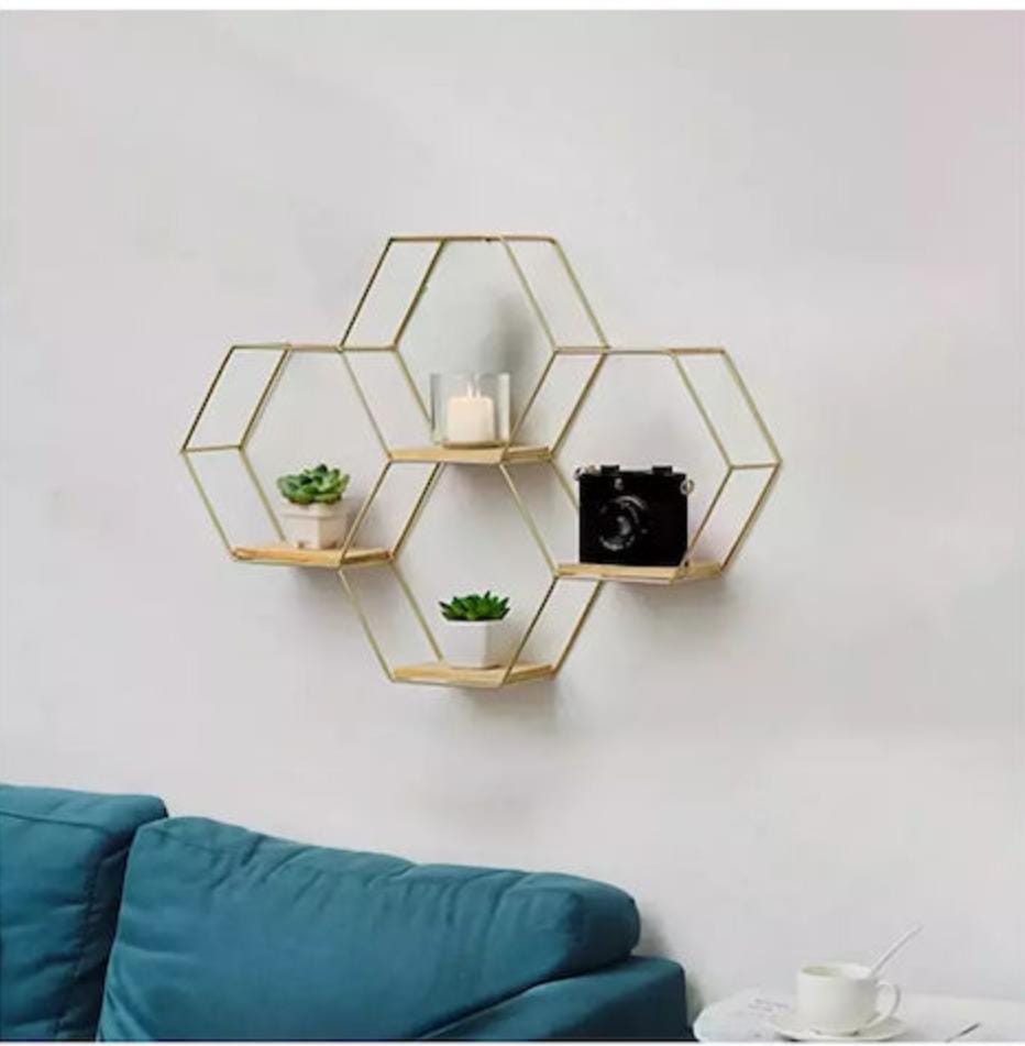 Dawood Lifestyle & Gadgets kes 4-piece gold hexagon floating wall shelf set with natural wood bases in a geometric honeycomb design for decorative home storage and display.