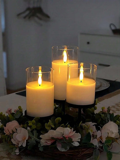 Set of three remote controlled LED flameless candles in acrylic material, heights 15cm, 13cm, and 10cm.0