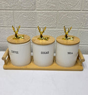 Three ribbed ceramic tea, coffee, and sugar canisters with bamboo lids and matching bamboo tray.