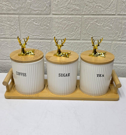 Three ribbed ceramic tea, coffee, and sugar canisters with bamboo lids and matching bamboo tray.