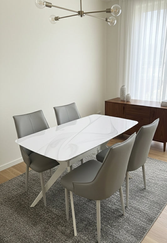 Glass top 4-seater dining table with four chairs.