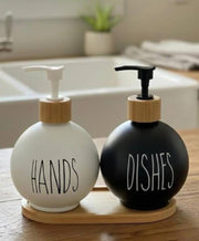 3-in-1 Ceramic soap and lotion dispenser set with black and white bottles on a bamboo base.