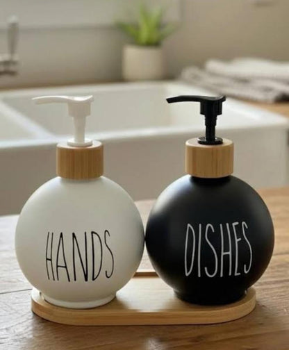 3-in-1 Ceramic soap and lotion dispenser set with black and white bottles on a bamboo base.