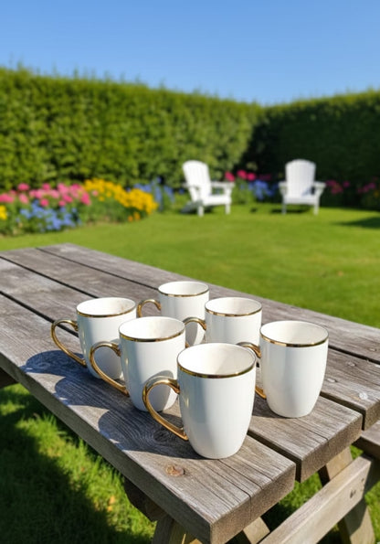 White ceramic cup with gold rim detail and 335 ml capacity.