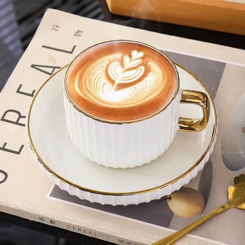 European style ceramic coffee and tea cup set with gold edge and matching saucers.