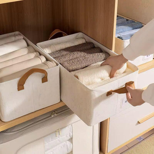 Beige steel frame storage basket with leather handles, 47 x 28 x 20 cm.
