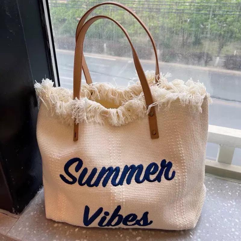 Large summer tote bag with button closure and spacious lightweight casual design. 