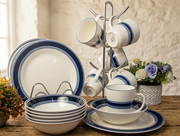 18-Piece ceramic dinner set with blue rim design including plates, bowls, and cups