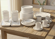 32-piece matte stoneware marble finish dinner set in black or white with plates, bowls, mugs, saucers, and platters
