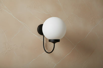 Black plug-in wall light with opal globe shade, modern E27 decorative lighting fixture with soft diffusion