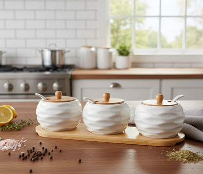 Ceramic four piece kitchen canister set with bamboo lids on countertop