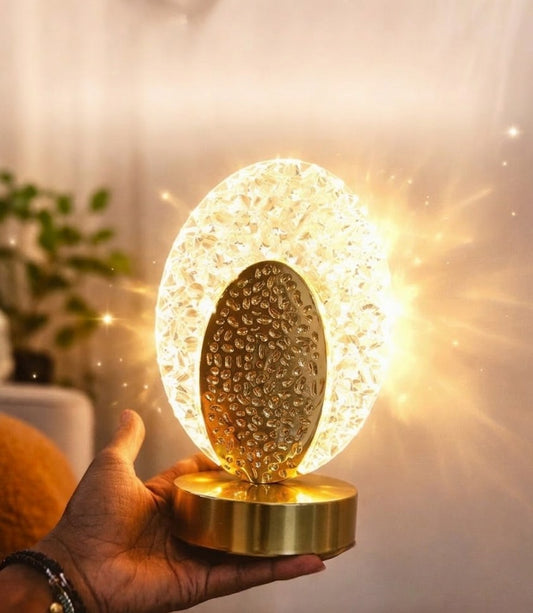 Luxury crystal table lamp with gold finish, elegant ambient lighting for bedside, living room, or office décor. 