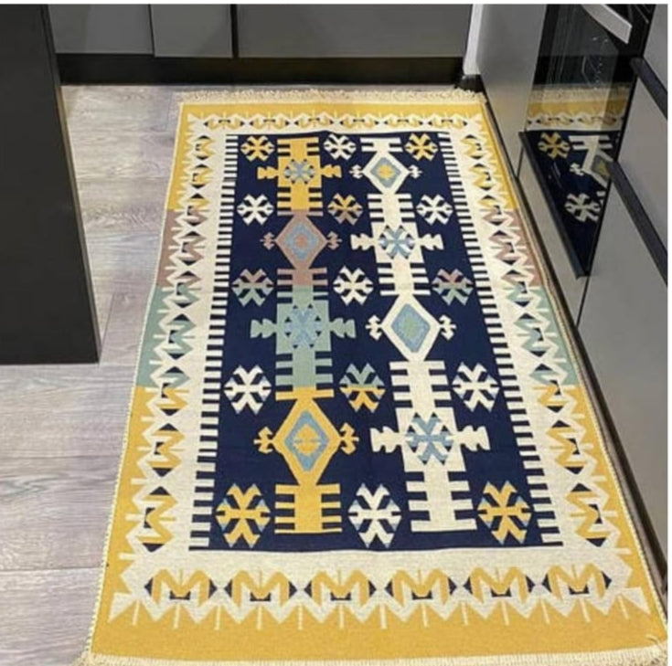 Flat woven Kilim tapestry rug used as a kitchen or bedside floor mat, size 60 x 125 cm.