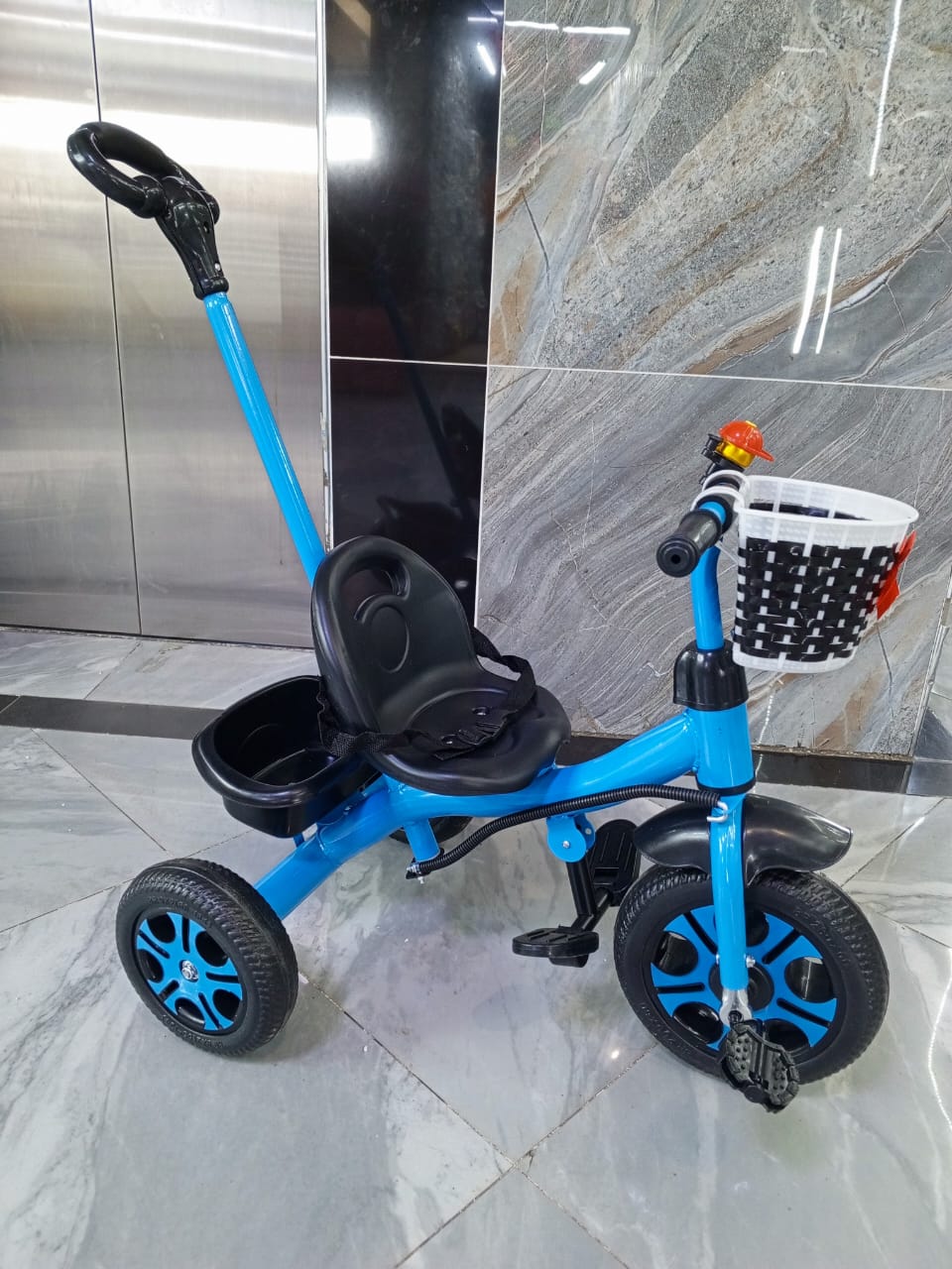 Kids push tricycle in pink and blue, safe and fun for toddlers and young children