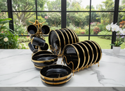 24-Piece Black and gold ceramic dinner set with plates, bowls, and cups.