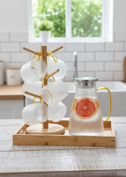 Transparent snowflake glass jug set with stand, tray, and six cups.