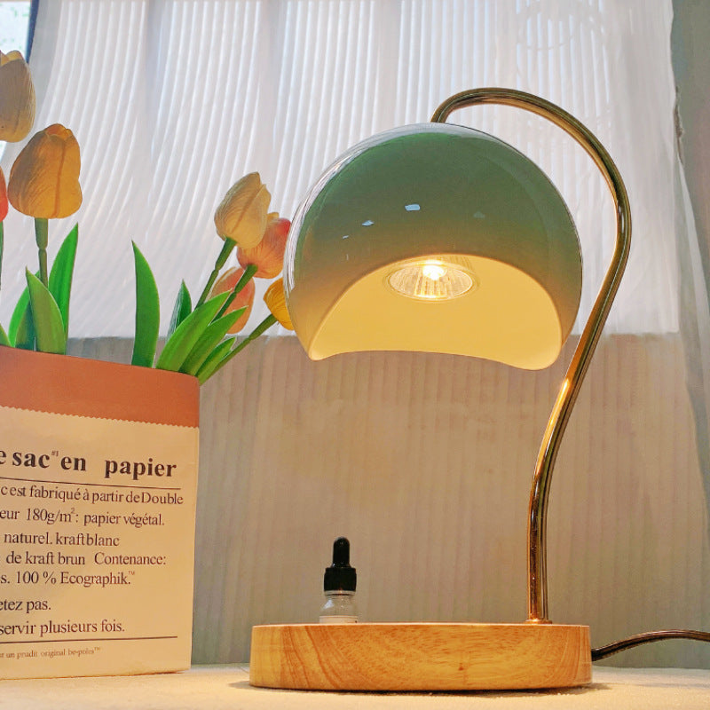 Electric candle warmer with a wooden base and metal frame for flameless fragrance and elegant home décor.
