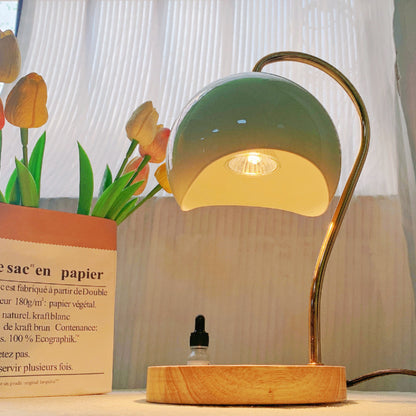 Electric candle warmer with a wooden base and metal frame for flameless fragrance and elegant home décor.