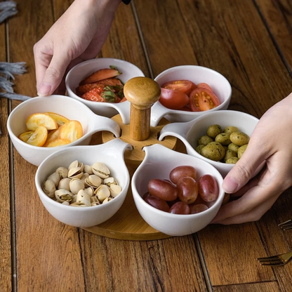 Six ceramic appetizer bowls arranged on a rotating bamboo serving tray.