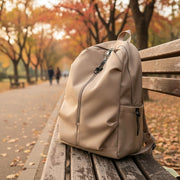 Oxford material laptop backpack in beige, black, and white colors.