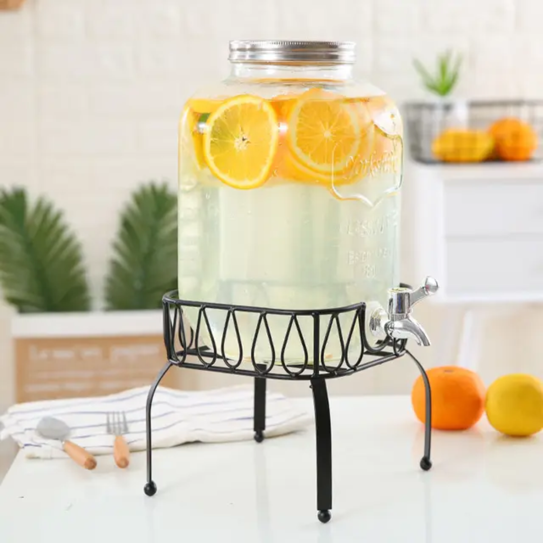 Glass beverage dispenser with metal stand and tap, available in 5L and 8L, ideal for serving drinks at home or events. 