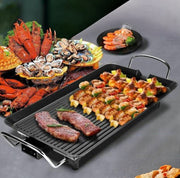 Electric non stick smokeless BBQ grill pan with large rectangular cooking surface.