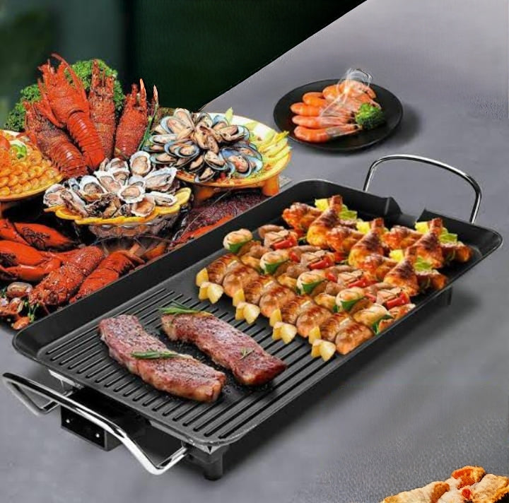 Electric non stick smokeless BBQ grill pan with large rectangular cooking surface.